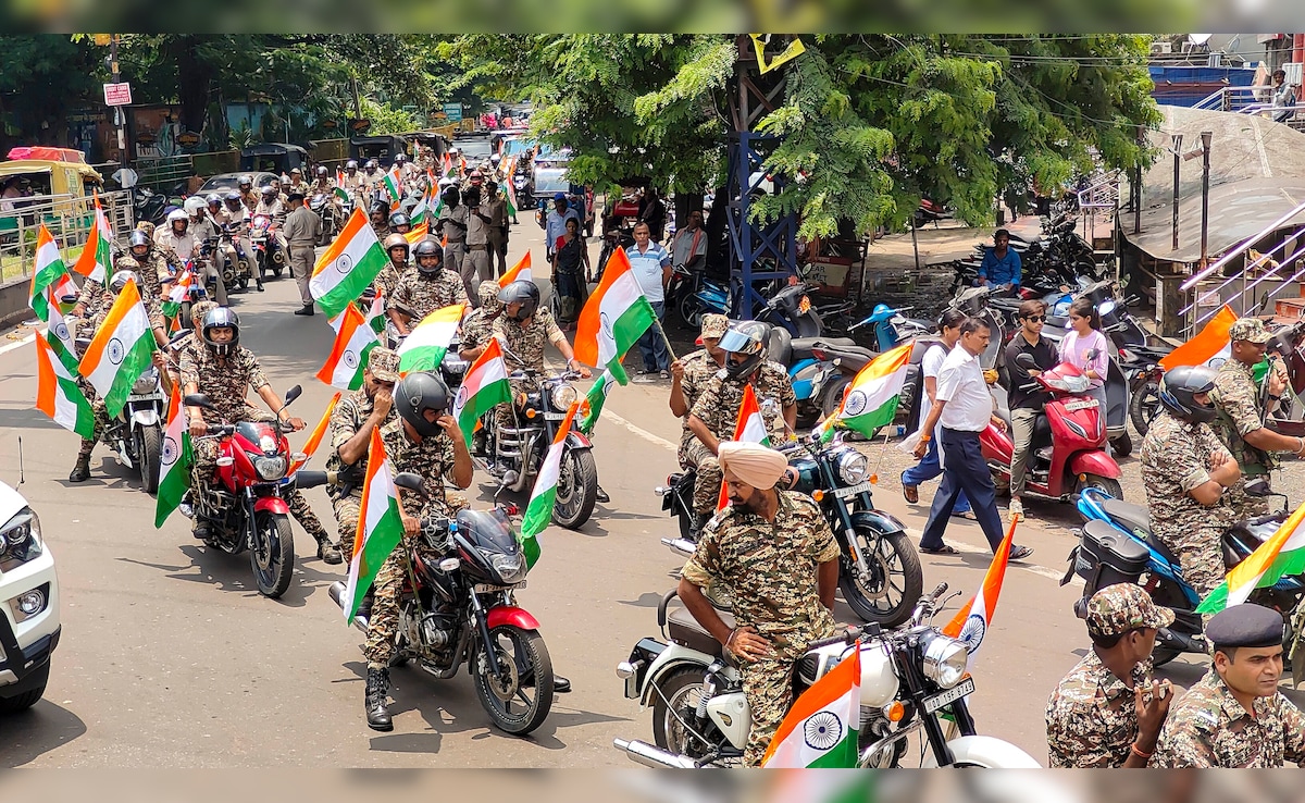 Security personnel take part in a bike rally under Har Ghar Tiranga campaign in Dhanbad