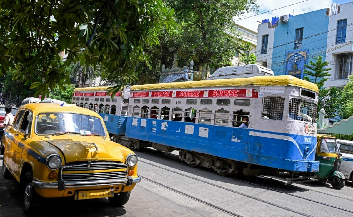 In this photo taken on September 8, 2024, passengers commute in a tram along a street in Kolkata.