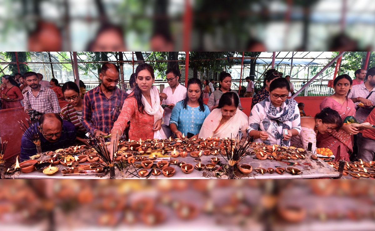 Devotees lights earthen lamps (Diya) at a Lord Ganesha temple