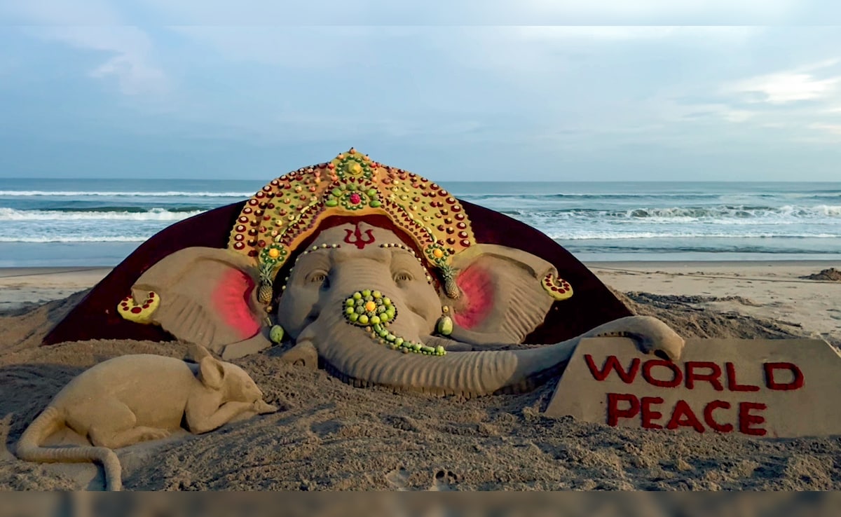 Sand artist Sudarshan Pattnaik creates a sand sculpture of Lord Ganesha using 20 types of fruits on the occasion of the Ganesh Chaturthi festival, in Mumbai