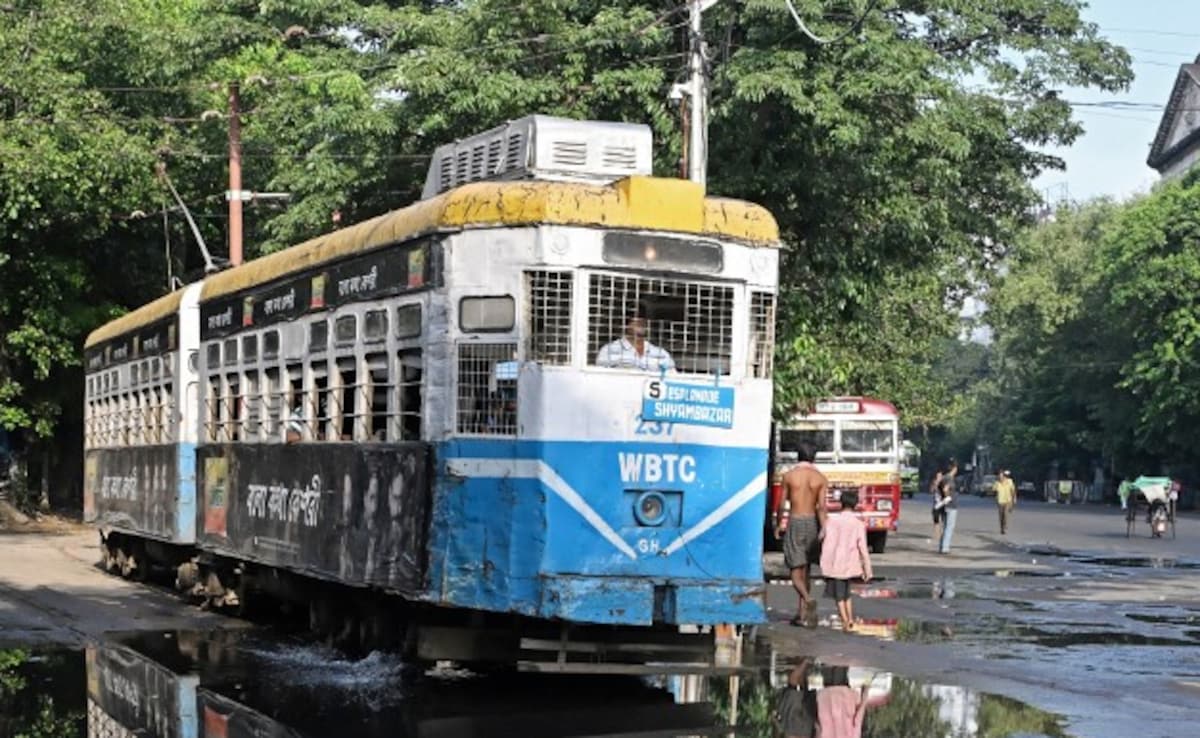 In this photo taken on September 18, 2024, passengers commute in a tram along a street in Kolkata