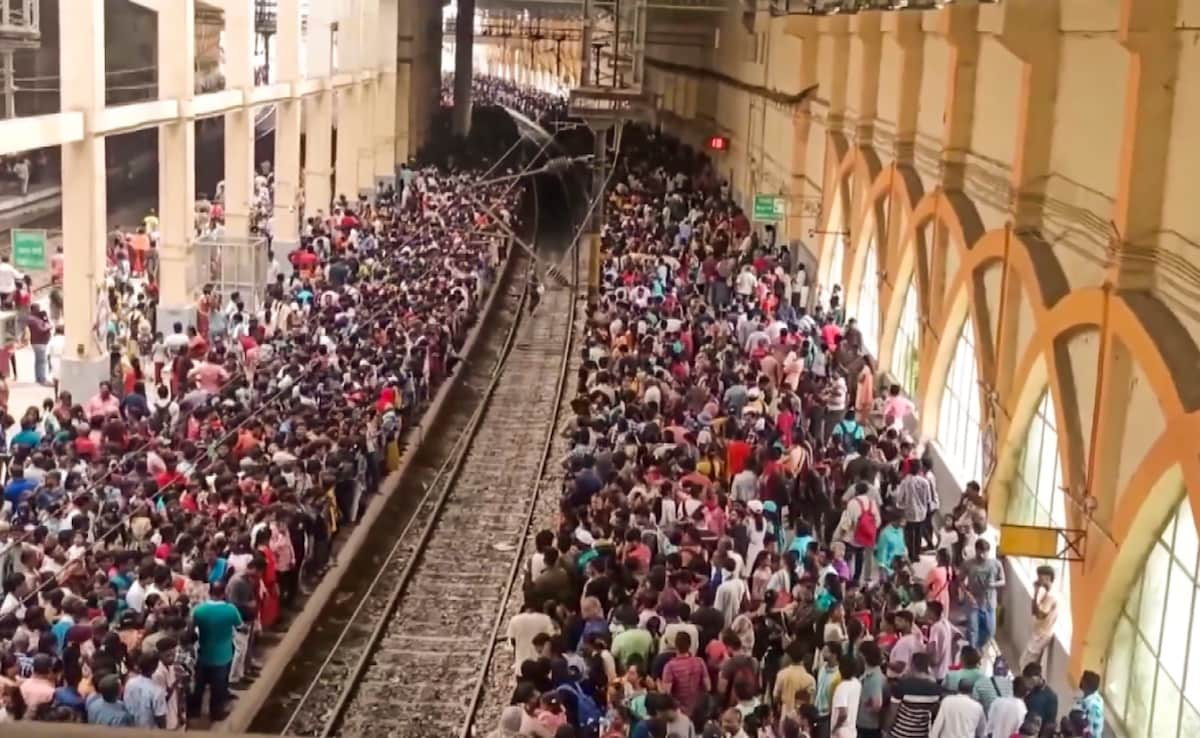 Passengers wait at the Velachery railway station to depart for an air show on the 92nd Indian Air Force at the Marina Beach in Chennai